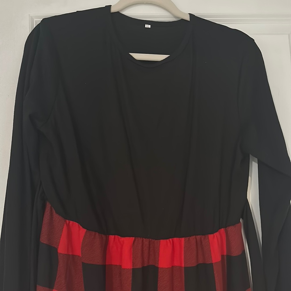 Long sleeved dress. Black on top and red and black plaid on the bottom skirt
